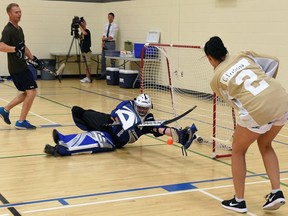 Carrie Babin (R) from team gold scores on team red goalie, Kyle Parkinson during a 62-hour-long floor hockey game at Laval High School gymnasium in Regina.  It's all part of a movie and trying to beat the Guinness World Record for the longest floor hockey game at the same time. They started playing today and will be playing through until Sunday. This game is part of a full-length feature movie that is being filmed in Regina currently called Talent. The film focuses around high school senior Kaylee's organization of the world's longest floor hockey game, so while filming for the movie they are actually trying to break the record in real life. DON HEALY / Regina Leader-Post