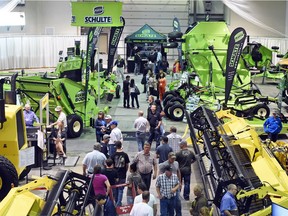 Farmers check out equipment at Canada's Farm Progress Show in Regina in June. Farm machinery and equipment sales were down year over year in May, according to Statistics Canada.