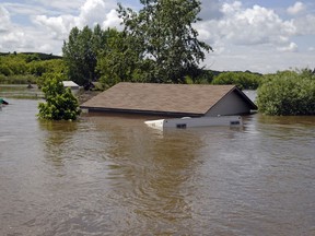 A view from a boat of a flooded home in the village of Roche Percee on Wednesday, June 22, 2011. Roche Percee is located approx. 20km's south east of Estevan.
