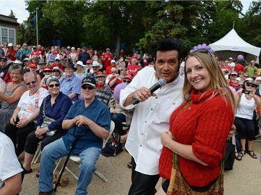 Rory Allen sings among the crowd as Gail Baran poses with him for a photo Canada Day celebrations at Government House in Regina, Sask. on Friday July 1, 2016.
