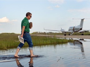 Saskatchewan Premier Brad Wall stepped across a flooded runway at the Melville airport to board a flight back to Regina after an aerial tour of flood-ravaged southeast Saskatchewan in 2014.