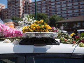 Flowers adorn a memorial outside the Dallas Police Headquarters on July 8, 2016.