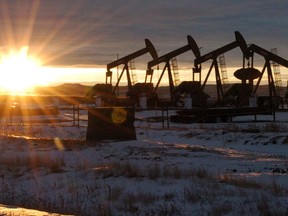 FILE - In this Jan. 14, 2015 file photo, some of the 60 rigs that are drilling surrounding McKenzie County, 40 percent of the rigs statewide, work in western North Dakota.  Released on Tuesday, April 21, 2015, unemployment rates fell in 23 U.S. states last month and rose in 12 as employers pulled back on hiring and a slowdown in oil and gas drilling caused big job losses in some states. (AP Photo/Matthew Brown, File)