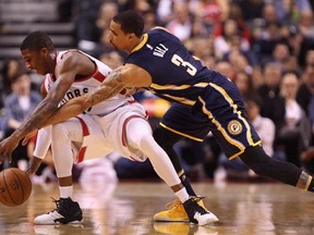 Toronto Raptors guard Delon Wright (55) nearly has the ball stripped away by Indiana Pacers guard George Hill (3) during the second half of NBA Basketball action in Toronto on Friday, April 8, 2016. Wright had arthroscopic shoulder stabilization on Monday to fix a labral tear in his right shoulder. THE CANADIAN PRESS/Peter Power