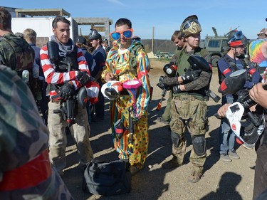 Adam Fletcher, center, playing for the Germans, dressed as a clown at an annual Second World War paintball re-enactment of the battle for Juno Beach at Prairie Storm Paintball near Moose Jaw, Sask. on Saturday Aug. 27, 2016.
