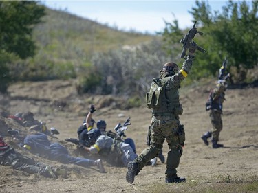 Allied solidiers raise their arms as a signal of their death at an annual Second World War paintball re-enactment of the battle for Juno Beach at Prairie Storm Paintball near Moose Jaw, Sask. on Saturday Aug. 27, 2016.