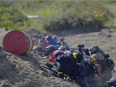 Allied troops take cover as the paintballs fly at an annual Second World War paintball re-enactment of the battle for Juno Beach at Prairie Storm Paintball near Moose Jaw, Sask. on Saturday Aug. 27, 2016.
