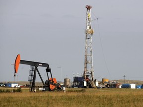 Pumpjack and drilling rig in the Weyburn area. The August sale of oil and gas drilling rights netted the province $10 million, with $8.8 million in the Weyburn-Estevan area.