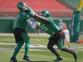 Saskatchewan Roughriders defensive linemen Justin Capicciotti, left, and Corvey Irvin participate in a drill in practice earlier this week.