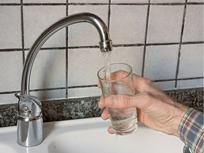 Filling glass of water from the kitchen tap, drinking water supply. Photo by fotolia.com