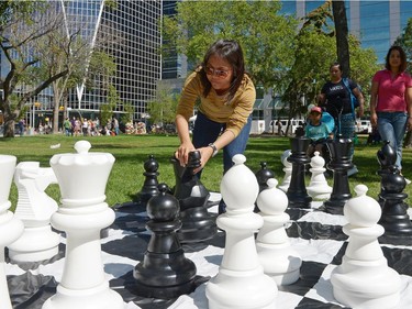 Josephine Velarde moves her knight during an outdoor chess match during I Love Regina Day held at Victoria Park in Regina, Sask. on Saturday Aug. 27, 2016.