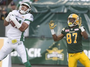 Justin Cox, left, shown making an interception against the host Edmonton Eskimos on July 8, has been the best of the Saskatchewan Roughriders' recruits in 2016.