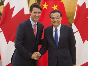 Chinese Premier, Li Keqiang, right, shakes hands with Canadian Prime Minister Justin Trudeau following a joint news conference at the Great Hall of the People in Beijing, China, Wednesday.