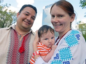 Marshall Pelletier, left, and Alina Hachkovska, right, hold their son Gabriel Pelletier at the 125th year of Ukrainian immigration to Canada festival held at Victoria Park in Regina, Sask. on Saturday Aug. 13, 2016. This year's festival is a cultural exchange between Ukrainian and Aboriginal communities.