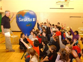 Hot air balloon pilot Marvin Schultz shows off a model of a SaskTel balloon in this 2003 photo taken at Regina's Albert School.