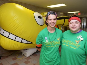 Michaela Sykora, left, and Dexton Bourne stand near an inflatable Camp fYrefly logo at Luther College in Regina on Aug. 14, 2016. The leadership retreat for LGBTQ youth is held yearly.