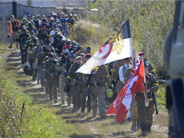 Participants walk to the battle field at an annual Second World War paintball re-enactment of the battle for Juno Beach at Prairie Storm Paintball near Moose Jaw, Sask. on Saturday Aug. 27, 2016.