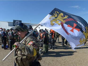 Peter Prokop carries a Knights Templar flag at an annual Second World War paintball re-enactment of the battle for Juno Beach at Prairie Storm Paintball near Moose Jaw, Sask. on Saturday Aug. 27, 2016.