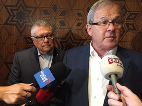 Agriculture Minister Lawrence MacAulay (right) and Public Safety Minister Ralph Goodale talk to reporters before meeting with farm leaders about grain transportation and other issues at a round table discussion in Regina Thursday.