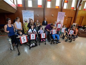 Children from Hope's Home hold up numbers that display the $150,000 donation made by the Mosaic Company in Regina on Thursday.