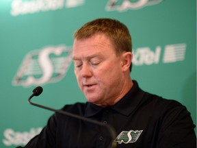 Saskatchewan Roughriders head coach Chris Jones reads a prepared statement about the CFL fines the Roughriders have just been given in Regina on Friday.