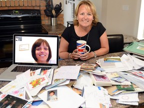 Corinne Toews sits in her home in Regina as Karen Golightly FaceTimes in on the laptop from Greenside, England. The pair have been friends from afar since 1981, when they became pen pals. Across the counter are letters, photos and gifts Karen has sent Corinne over the past 35 years.