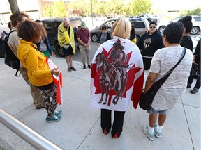 A small group of people gathers outside the Provincial Court of Saskatchewan in Regina for a Justice for Colten rally on Thursday.  Colten Boushie, a 22-year-old man was killed near Biggar.