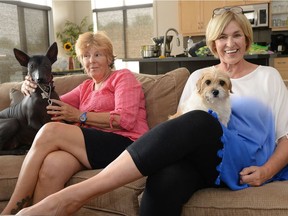 Peggy Martin-McGuire, left, along with rescue dog Chola and Paulette Riou with rescue dog Monica, pose for a photo in Regina on Monday.