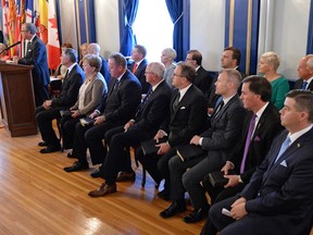 Premier Brad Wall, left, introduces a new provincial cabinet at Government House in Regina on Tuesday.