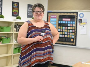 Courtney Horsman holds her prop microphone in her classroom at Deshaye Catholic School.