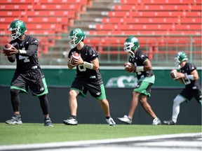 Saskatchewan Roughriders quarterbacks, from left,  Darian Durant, Mitchell Gale, Vad Lee and G.J. Kinne work on a drill during Tuesday's practice.