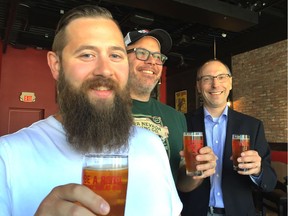 Savouring glasses of Rebellion Brewing's new summer beer Three Times a Charm are (left to right) amateur brewer Joel Forsythe, Rebellion's brewmaster Mark Heise and Jim Fallows, president of the board of the Regina Open Door Society, chosen to get a share of the proceeds from the sale of each pint of the ginger-and-fruit-flavoured beer.