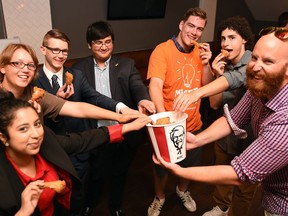 Jeph Maystruck (R) hands out KFC as a reward to student participants at the Big Idea Camp. Students from left are, Noor Jahan Imran, Rylie Reichel, Ryan Aird, Arslan Azeem, Jordan Tholl and Sterling Brown. The camp is a business program for high school students that has been running this week. DON HEALY / Regina Leader-Post