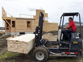 Norm Cowan with Co-op unloads lumber on the 6200 block of Balzer Street.  Regina home builders started foundations on 200 housing units in July, up eight per cent from 185 in July 2015, thanks to an increase in single-family housing starts.
