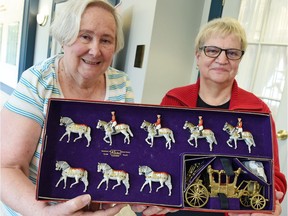 Janice Routley (left) head of the organizing committee for the Government House Historical Society's 16th annual antique and collectibles auction, and appraiser Isabelle Zohner  with part of a Queen Elizabeth coronation set that will be donated to Government House.  The auction takes place on August 20th.