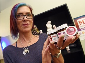 Kelly Csada shows a selection of marijuana-infused creams and salves she sells at Kelz Medical Services Corp.