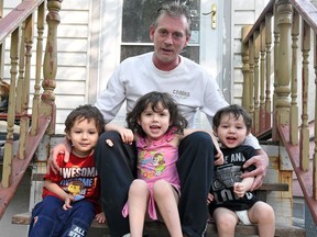 Daryl Holmes with his children from left, Riel, 3, Celine, 4, and Daryl Junior, 2. Holmes spent several months last year in Ranch Ehrlo's family treatment program, and now he has custody of his three young children.