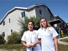 REGINA SK: AUGUST 29, 2016 – Shawna Oochoo (L) and Sherie McKay (R) of White Pony Lodge at an apartment building at the Corner of Dewdney and Angus.  The building was the site of a couple fires and is now boarded up but has now become a place where drug addicts have been frequenting. White Pony Lodge is calling for action and would like the building torn down for safety reasons. DON HEALY / Regina Leader-Post