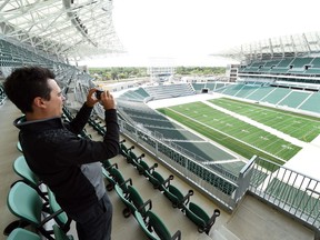 CJME's Jamie Nye takes a picture during Wednesday's media tour of the new Mosaic Stadium.