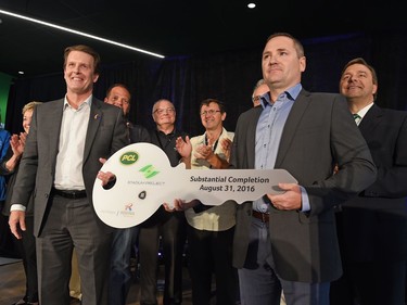 PCL district manager Sean Hamelin presents Regina mayor Michael Fougere the keys to the new Mosaic Stadium in Regina during a media tour.