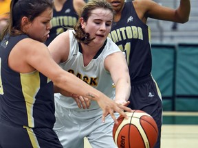 Kyla Shand, centre, of Saskatchewan fights for the ball with Robyn Boulanger, left, and Jillian Duncan of Manitoba during the under-17 bronze-medal game Saturday at the Canada Basketball under-15 and under-17 girls basketball championships at the University of Regina.