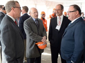 Premier Brad Wall (left) chats to Minister of the Economy Bill Boyd (right) at an event in March, 2015.