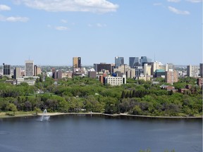 Regina downtown buildings rise above the trees as seen from atop the Saskatchewan Legislature dome.