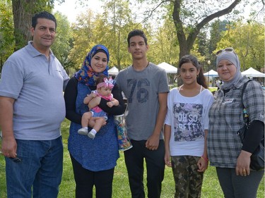 Saad Ajeel, Mina Mohammed holding her baby Basmala, Mohammed Ajeel, Maryam Mohammed, and Sarab Khudhur, from left, at I Love Regina Day held at Victoria Park in Regina, Sask. on Saturday Aug. 27, 2016.