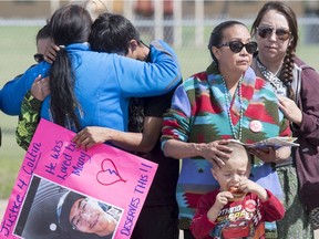 Elder Jenny Spyglass, left, comforts William Boushie, brother of Colten Boushie, and Debbie Baptiste, his mother, right, outside of court during a bail hearing for Gerald Stanley in North Battleford on Aug. 18. Colten Boushie, a 22-year old First Nations man, was shot and killed on Aug. 9 after the vehicle he was in drove onto a farm west of Saskatoon.