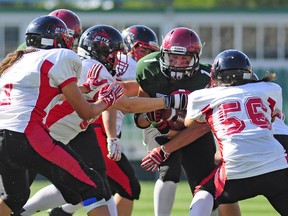 Saskatchewan running back Carmen Agar ploughs into Quebec's defence during the gold-medal game at the Canadian Women's Football Championship on Sunday at Mosaic Stadium.