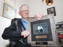 Retired University of Saskatchewan crop development researcher Al Slinkard in his Saskatoon home, Thursday, July 21, 2016 holding an award for a seed of the year (Laird Lentil) which he developed. 