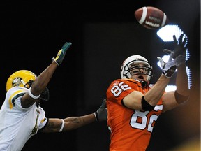 Jason Clermont, right, shown catching a touchdown pass for the B.C. Lions in 2008, is about to be inducted into the CFL team's Wall of Fame.