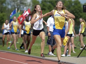 Regina's Chloe McEachern, left, finishes just behind Alberta's Catherine Kluyts during a relay at the Western Canada Challenge track and field meet Sunday at the Canada Games Athletics Complex.