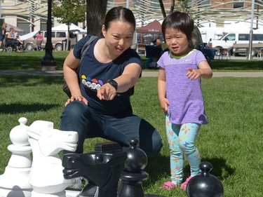 Ting Ting Sun points out chess pieces to her daughter Amanda at I Love Regina Day held at Victoria Park in Regina, Sask. on Saturday Aug. 27, 2016.
